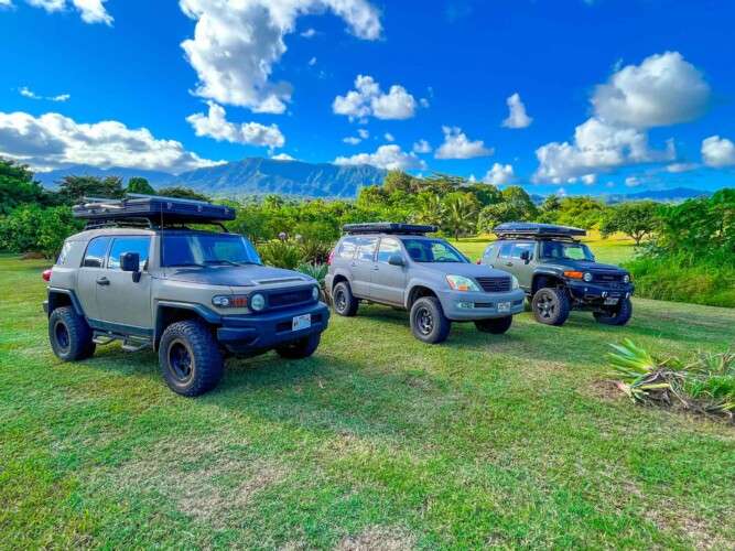 three campers in a meadow