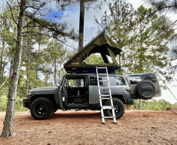 camper on camaping site with rooftop tent