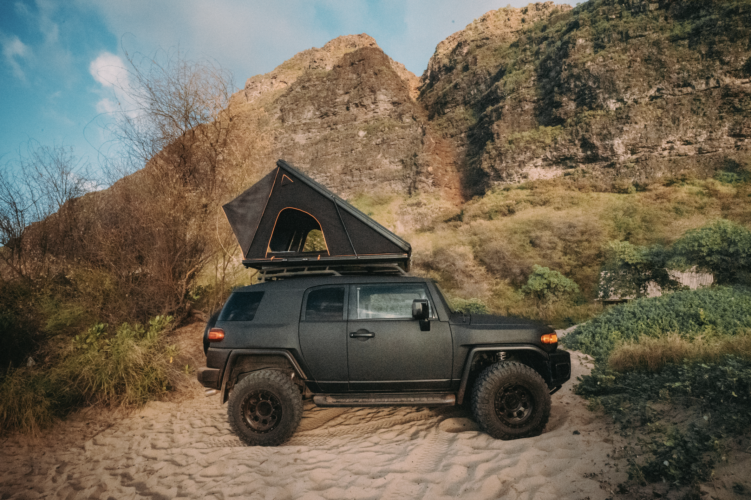 black jeep with camping tent at rooftop