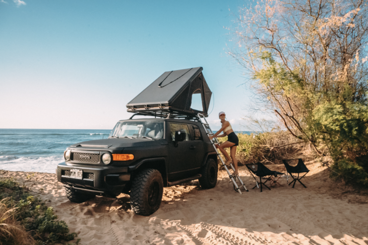 woman climbing on the rooftop tent