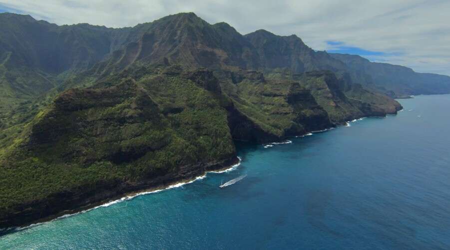 blue water lake surrounded between green mountains