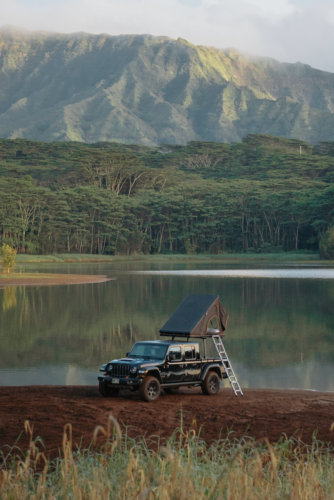 a distant view of jeep gladiator with truck camper