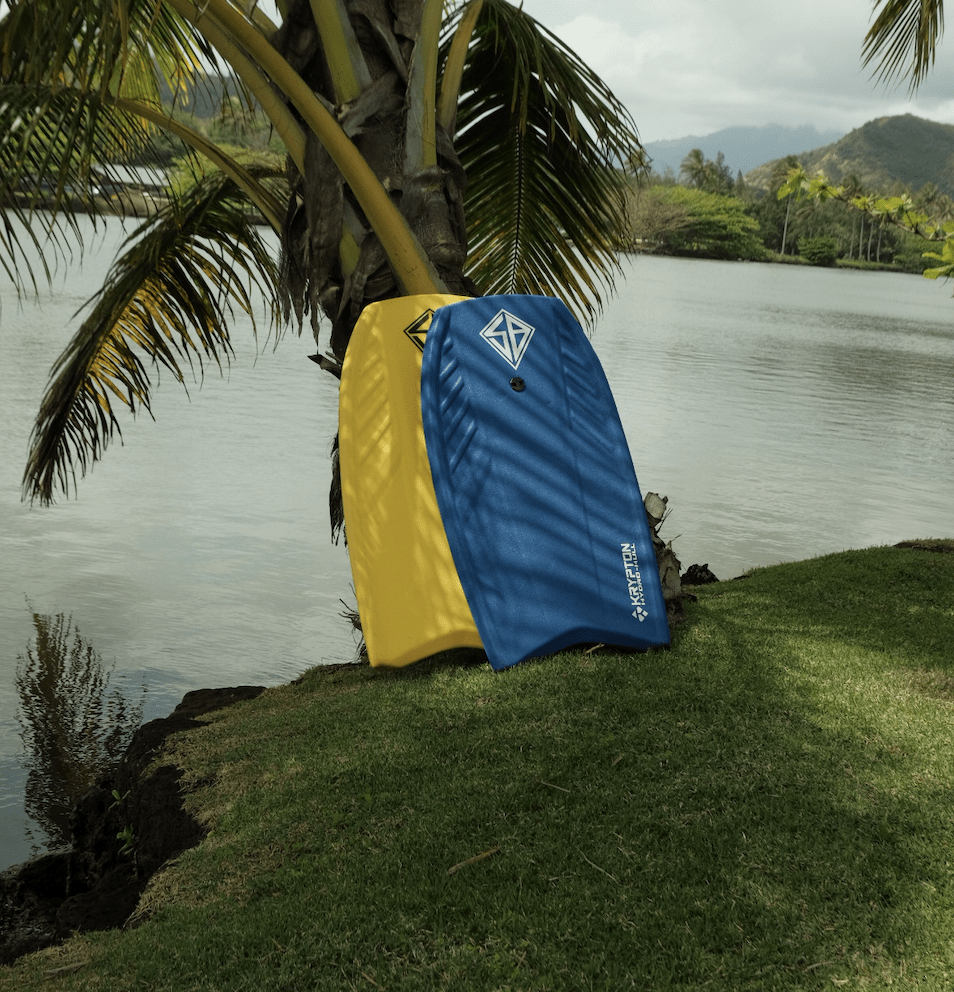 yellow and blue surfboards near palm tree